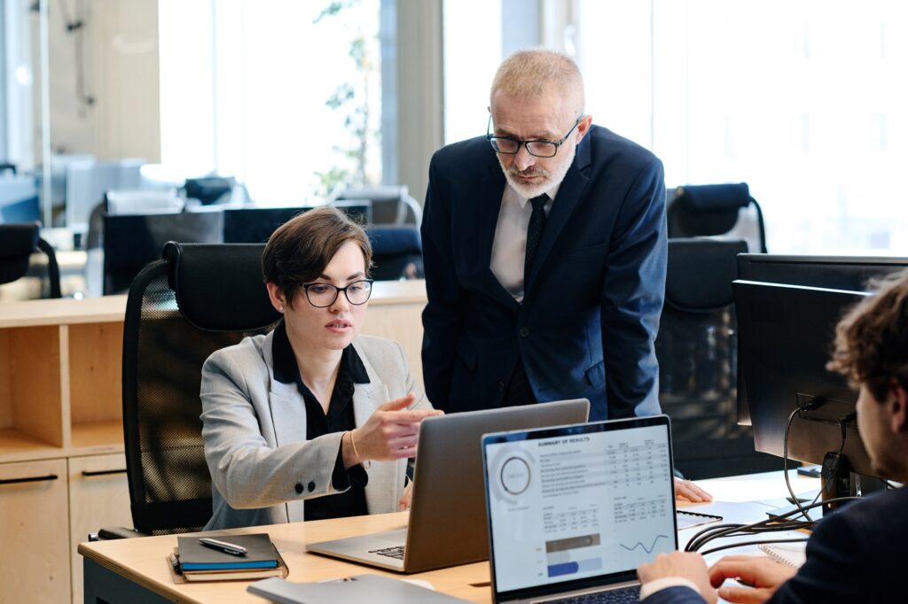Office worker consulting with manager at office